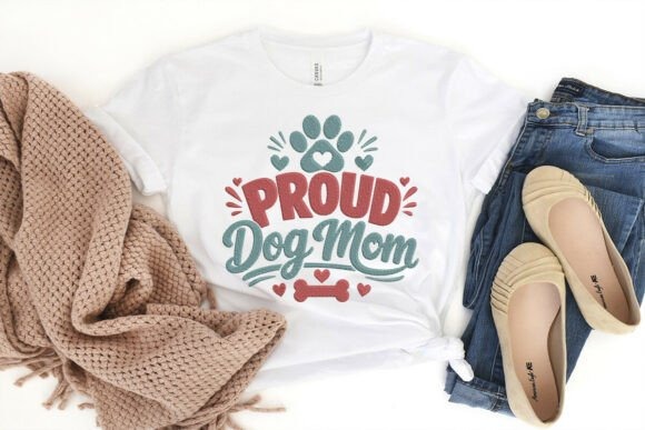 White t-shirt with Etsy embroidery designs featuring Proud Dog Mom text, paw prints, hearts, and decorative details