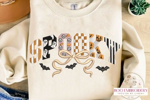 Etsy embroidery designs spelling spooky with Halloween-themed patterns and bats on a cream shirt